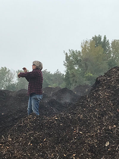 Amy on her compost pile
