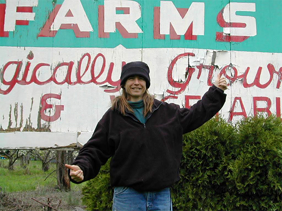 Vintage shot of Amy in front of farmstand sign