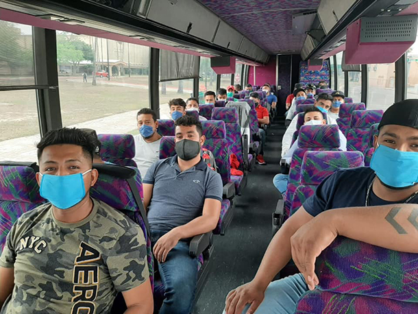 H2A workers on bus to farm